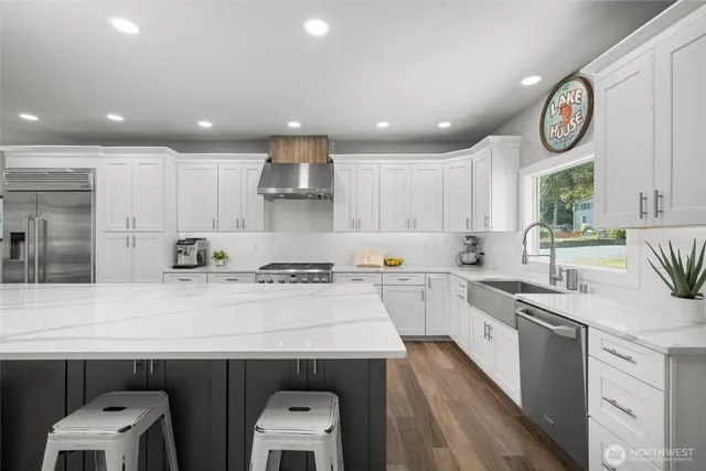 a kitchen with a sink a stove cabinets and a refrigerator