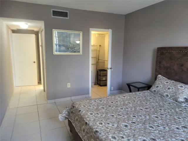 a bedroom with a bed and a cabinets