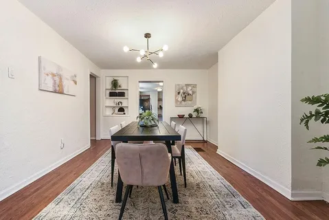 a dining room with furniture and window