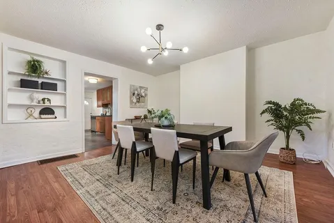 a view of a dining room with furniture and wooden floor