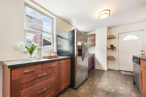 a view of a kitchen with a sink and refrigerator