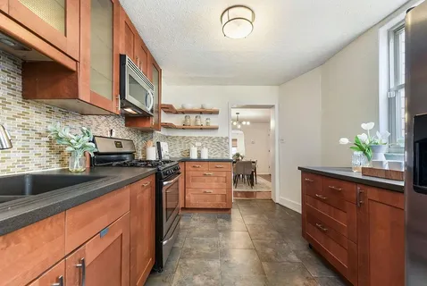 a kitchen with stainless steel appliances granite countertop a sink and cabinets