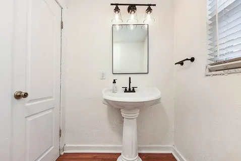 a bathroom with a sink a mirror and shower