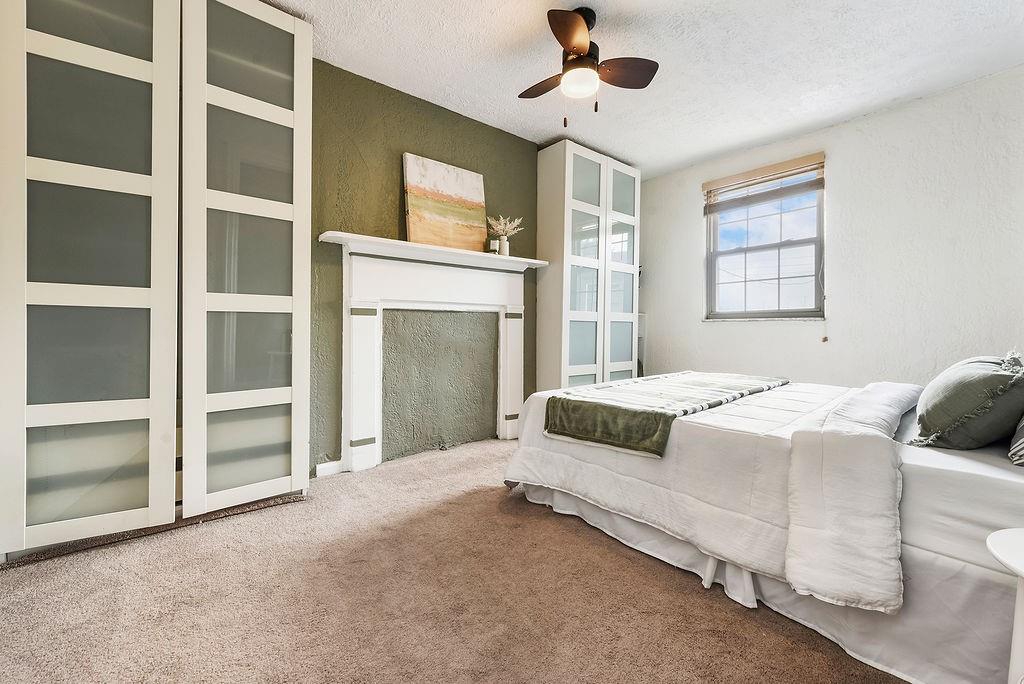 1302 Boyle Street Pittsburgh, PA 15212 - Photo 23 of 50 a bedroom with a bed and a fireplace