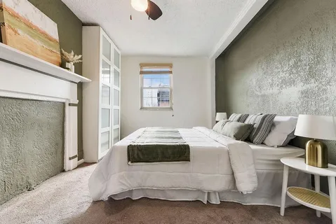a bedroom with a bed and a window