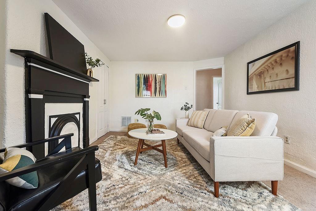 1302 Boyle Street Pittsburgh, PA 15212 - Photo 29 of 50 a living room with furniture a flat screen tv and a fireplace