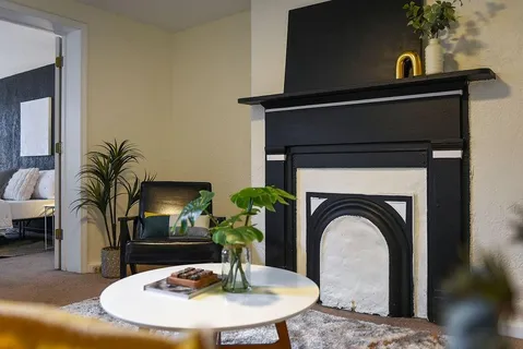 a living room with furniture and potted plant