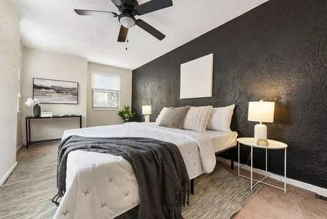 a spacious bedroom with a bed and window