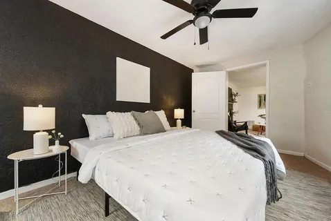 a bedroom with bed and window