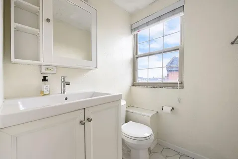 a bathroom with a sink toilet and vanity
