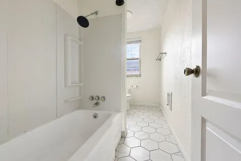 a bathroom with a bathtub and a shower