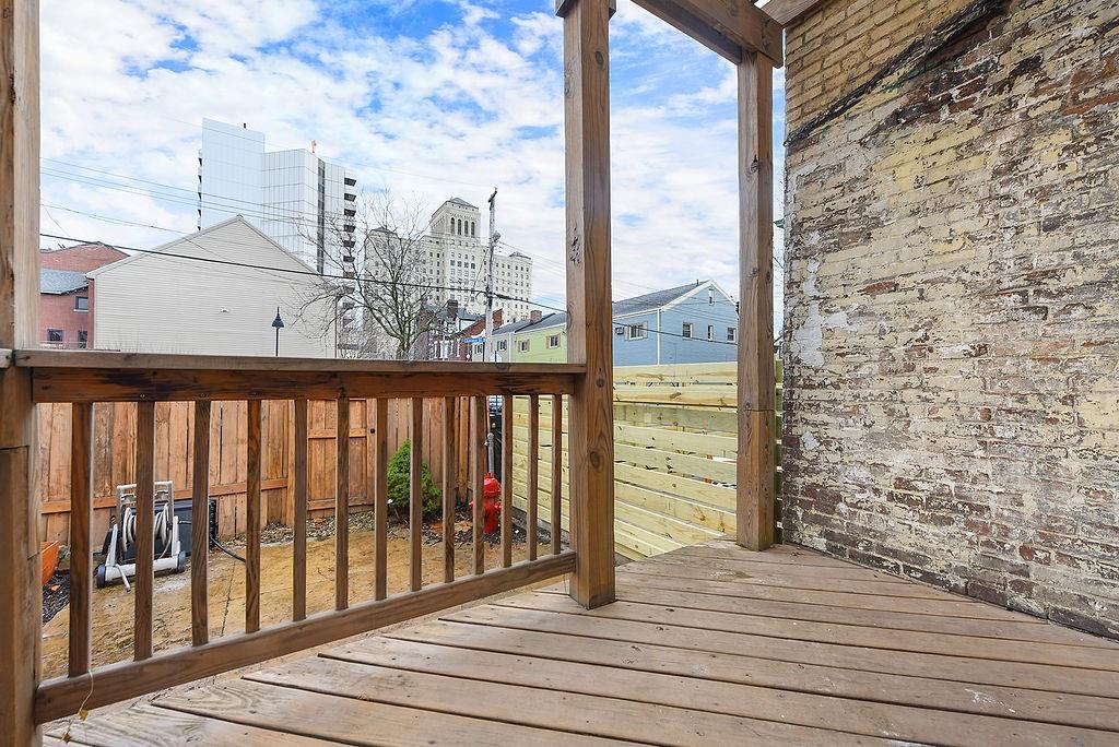 1302 Boyle Street Pittsburgh, PA 15212 - Photo 46 of 50 a view of a balcony with wooden floor and fence
