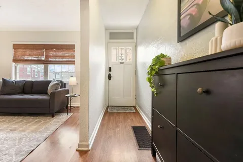a living room with furniture and a potted plant