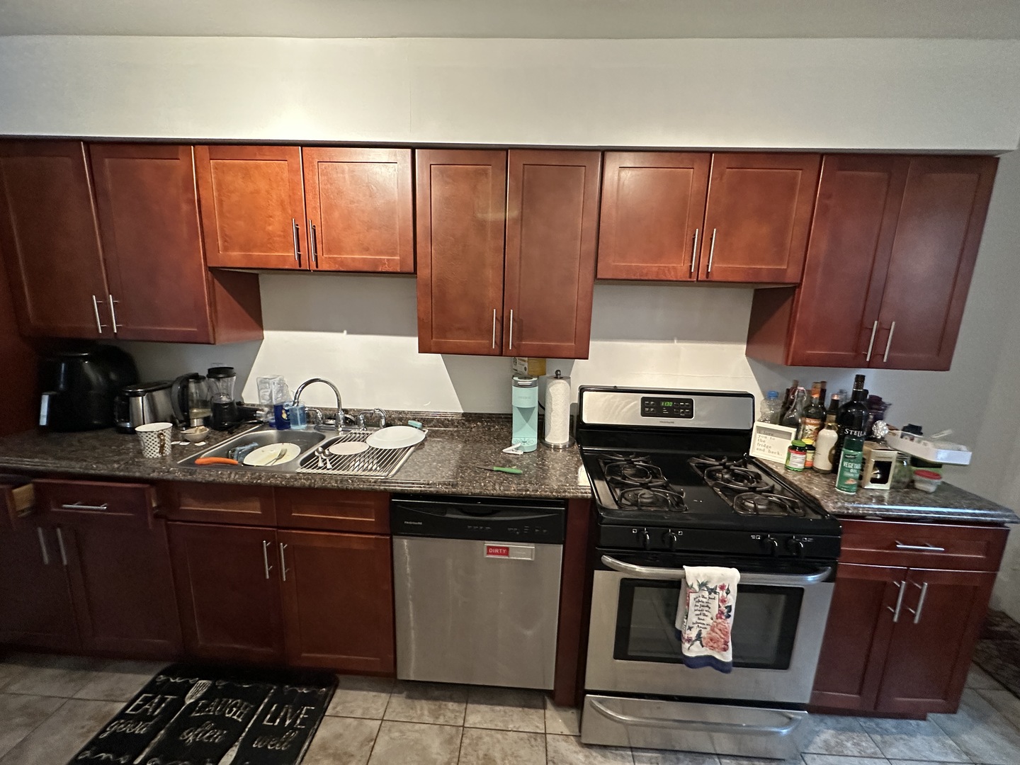 1127 North State Street, Unit 2A Chicago, IL 60611 - Photo 2 of 11 a kitchen with a sink a stove and cabinets