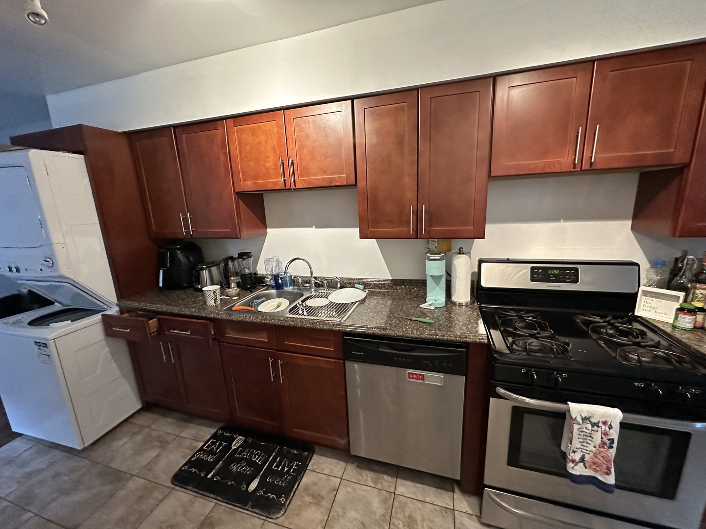 1127 North State Street, Unit 2A Chicago, IL 60611 - Photo 3 of 11 a kitchen with granite countertop wooden cabinets and a stove top oven