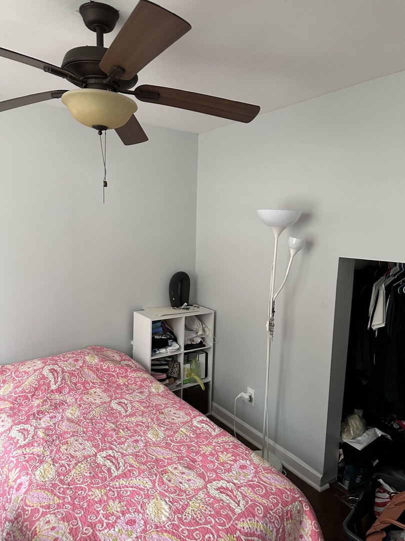 1127 North State Street, Unit 2A Chicago, IL 60611 - Photo 7 of 11 a bedroom with a bed and a chandelier