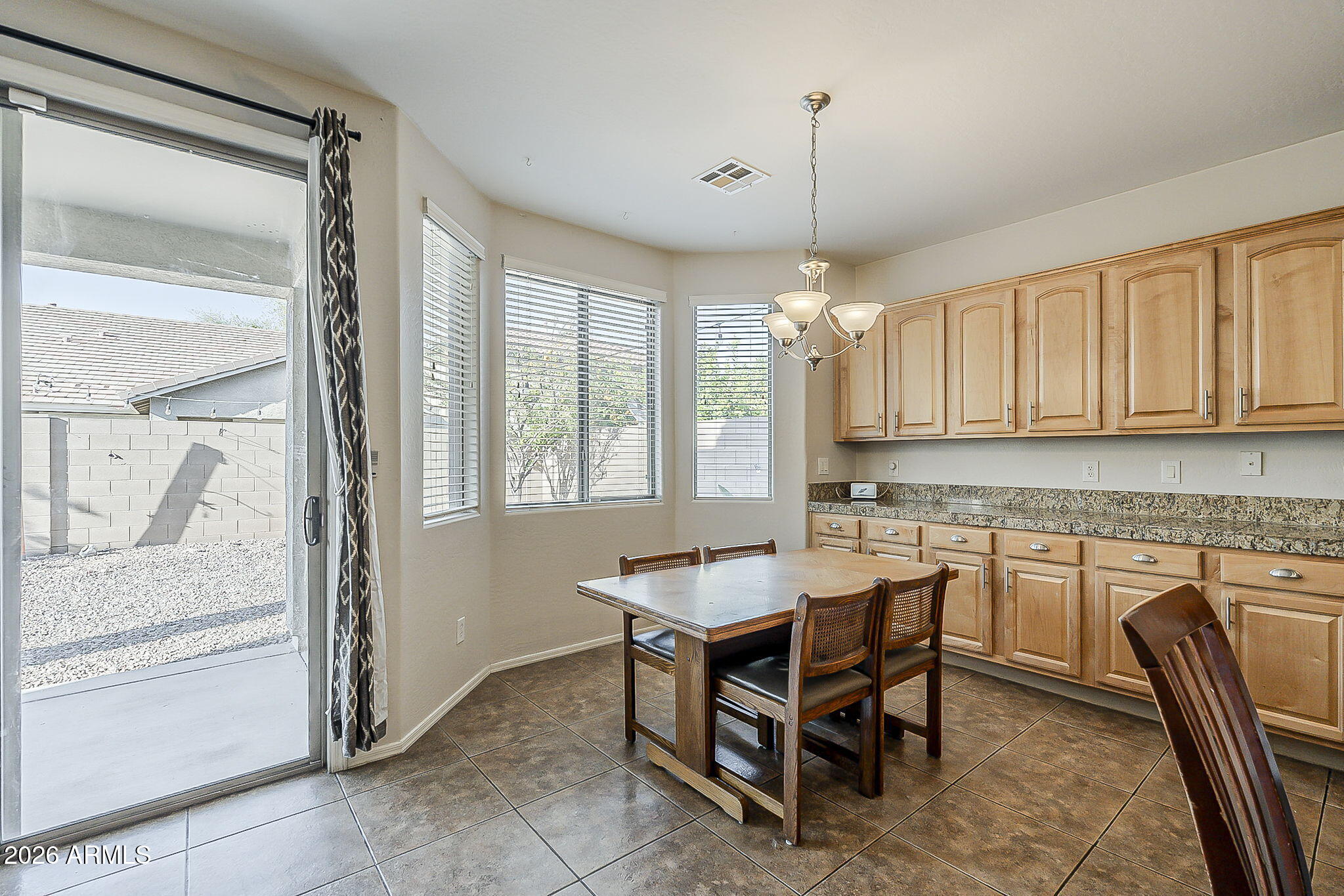 3816 East Phelps Street Gilbert, AZ 85295 - Photo 15 of 47 a kitchen with a sink a table and chairs in it