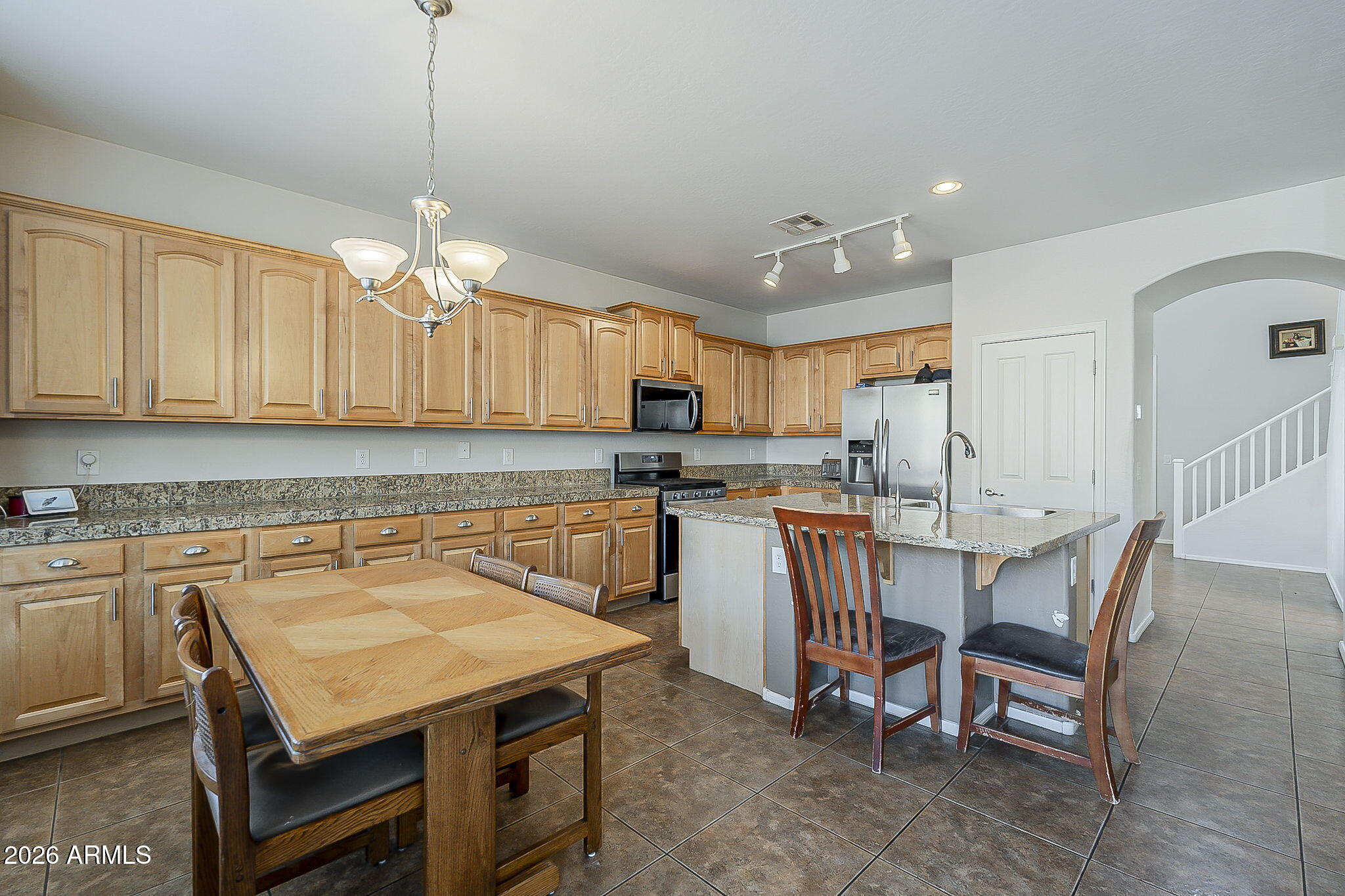 3816 East Phelps Street Gilbert, AZ 85295 - Photo 16 of 47 a kitchen with a table chairs microwave and cabinets
