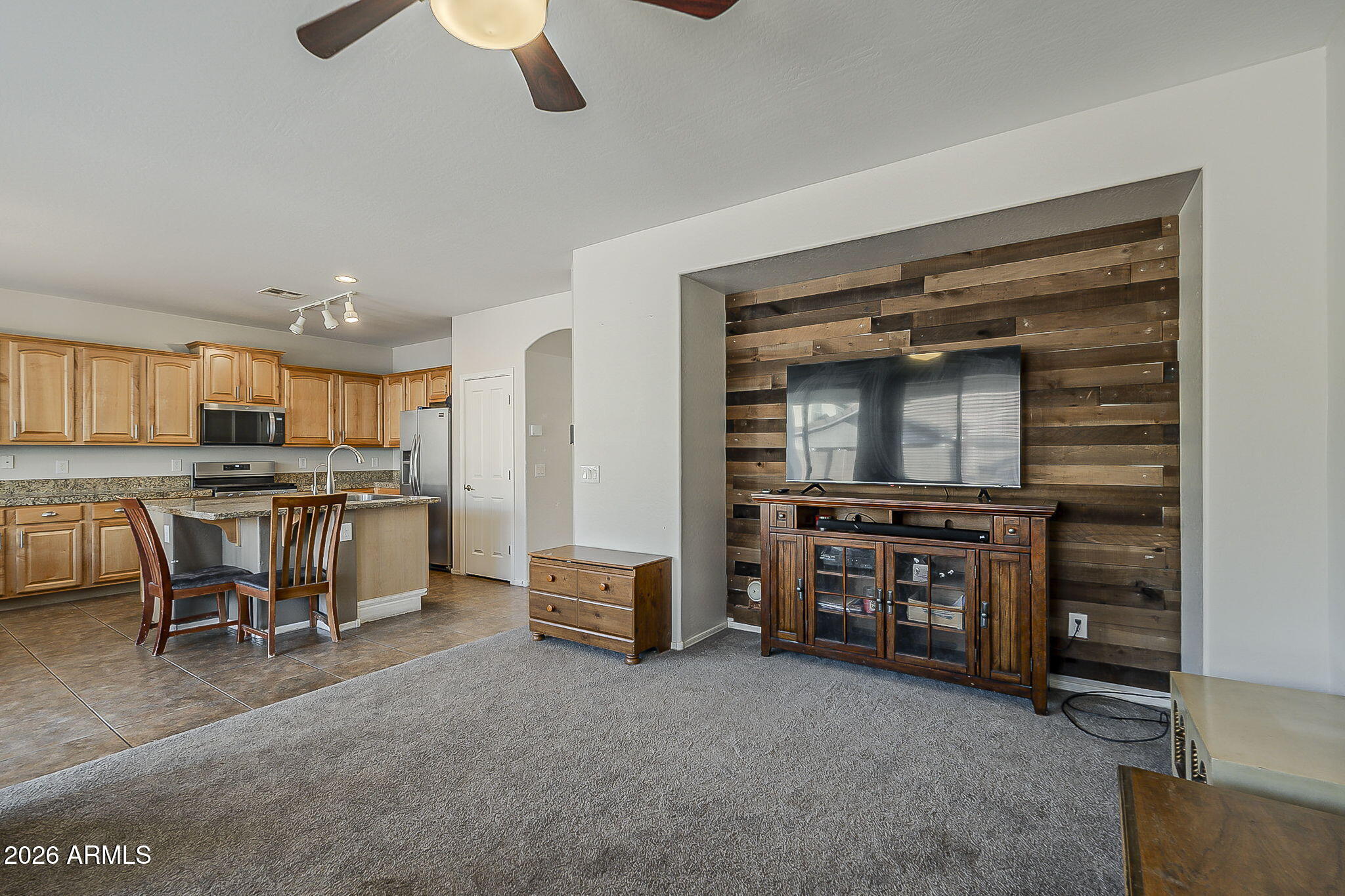 3816 East Phelps Street Gilbert, AZ 85295 - Photo 20 of 47 a open kitchen with stainless steel appliances kitchen island granite countertop a stove and a sink