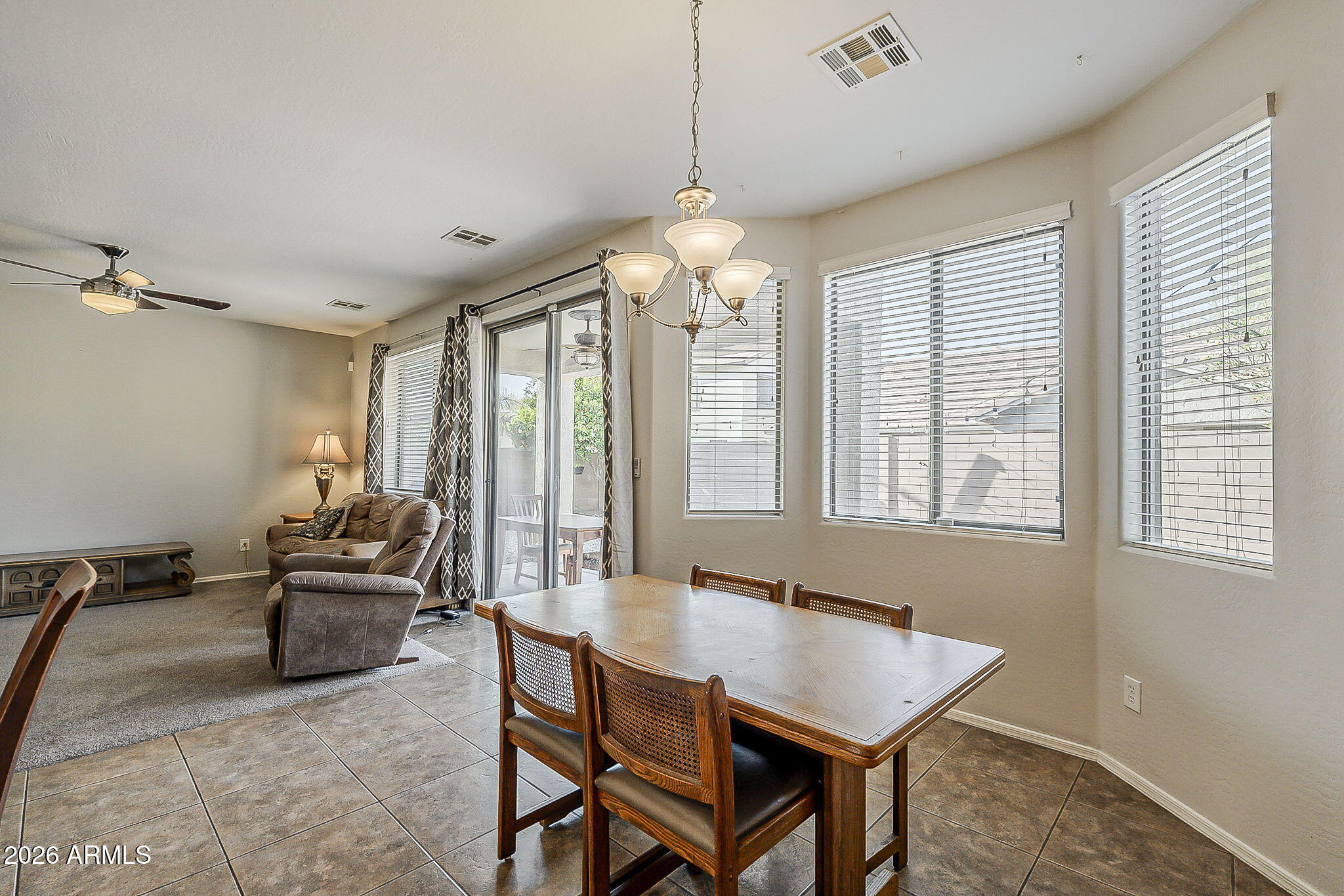 3816 East Phelps Street Gilbert, AZ 85295 - Photo 21 of 47 a living room with furniture and a chandelier