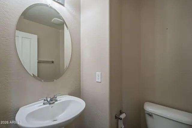 a bathroom with a sink a mirror and toilet