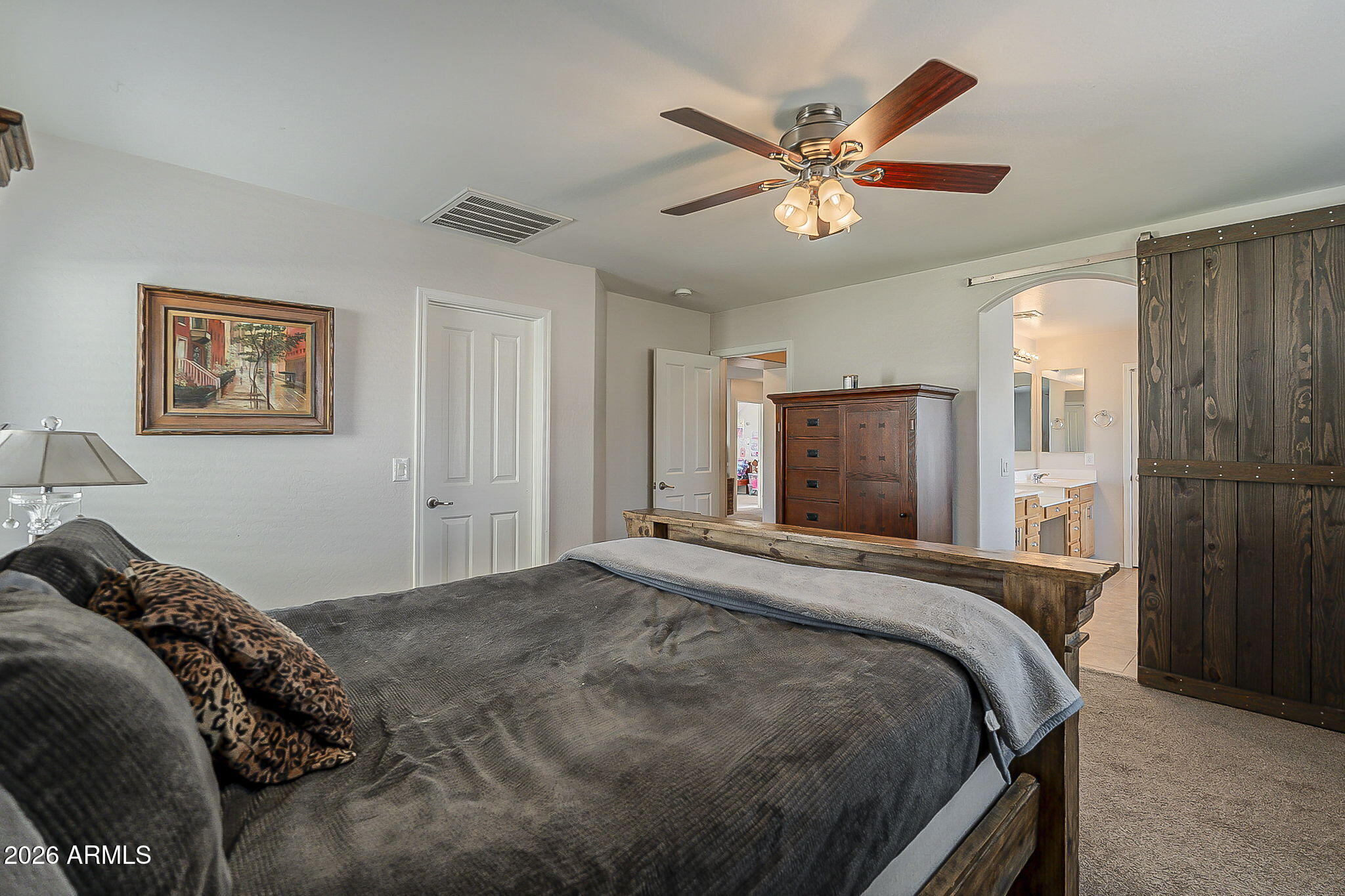3816 East Phelps Street Gilbert, AZ 85295 - Photo 26 of 47 a bedroom with a large bed and a ceiling fan