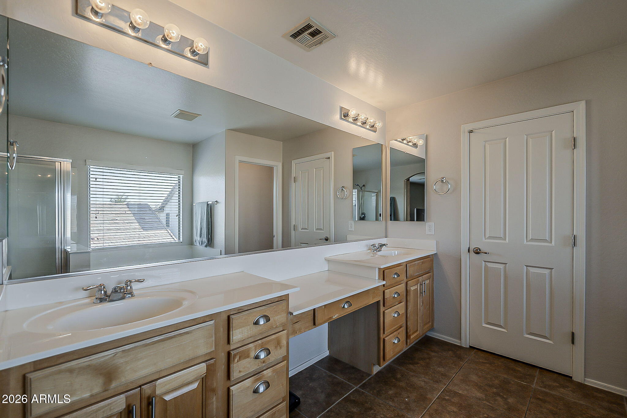3816 East Phelps Street Gilbert, AZ 85295 - Photo 29 of 47 a spacious bathroom with a granite countertop double vanity sink a mirror and a bathtub
