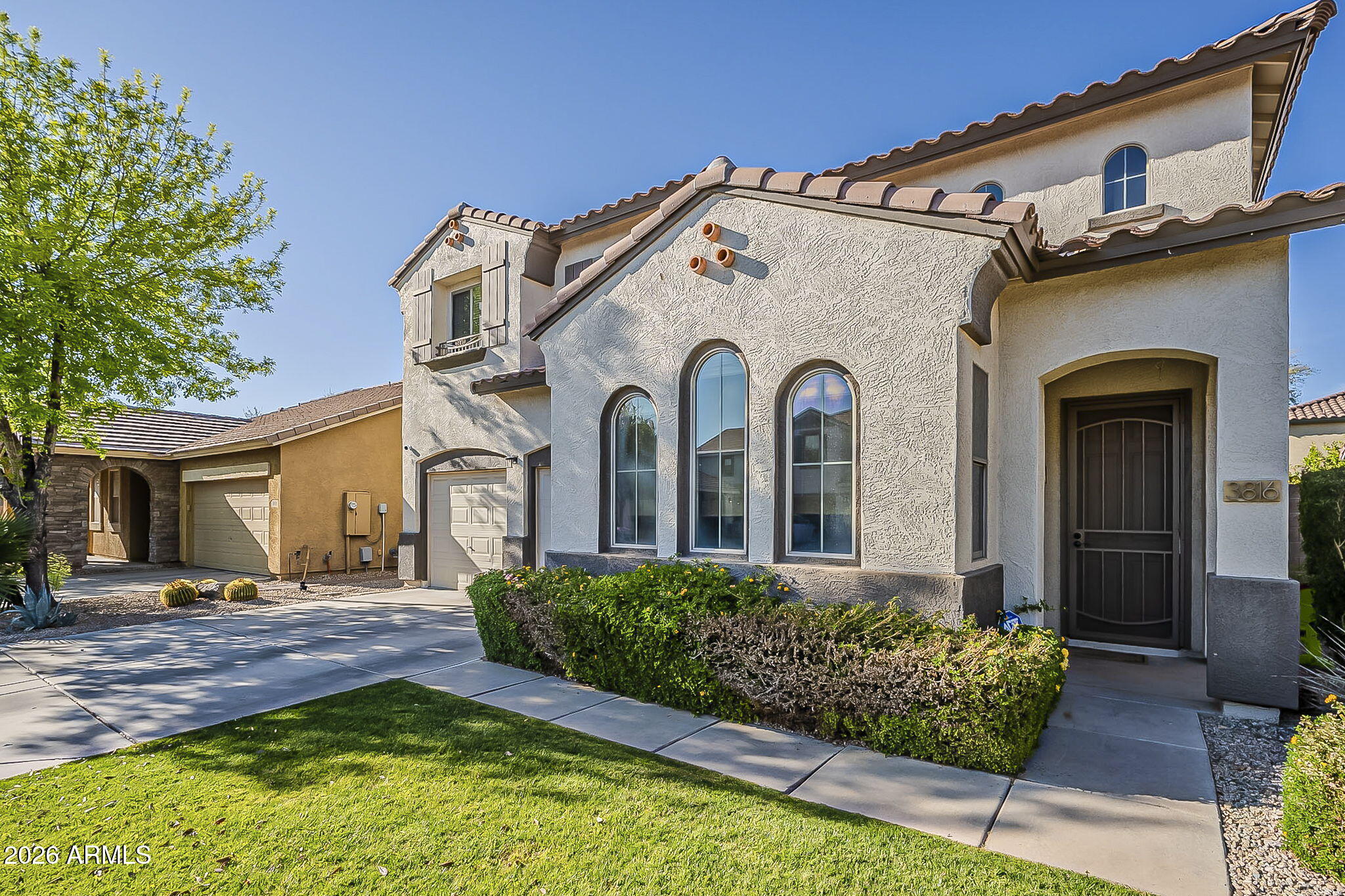 3816 East Phelps Street Gilbert, AZ 85295 - Photo 3 of 47 a view of a house with a small yard and potted plants