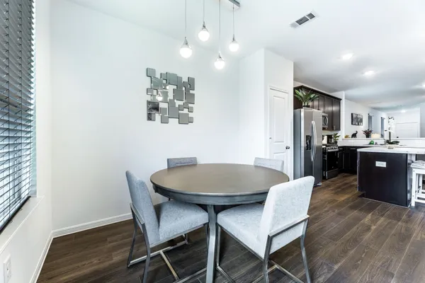 a view of a dining room with furniture and wooden floor