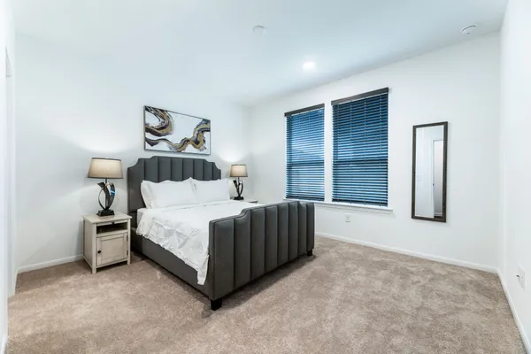 a spacious bedroom with a bed and a window