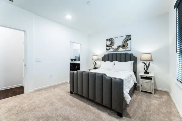 a bedroom with a bed and cabinets