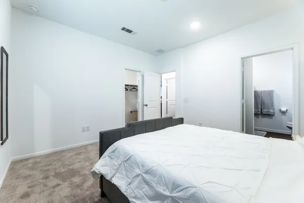 a bedroom with a bed and a mirror
