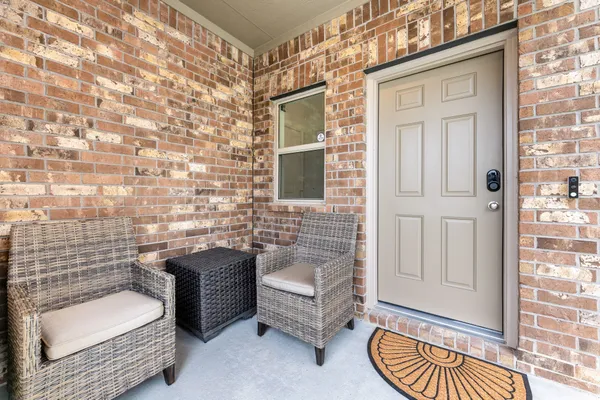 a view of a door and chair in the patio