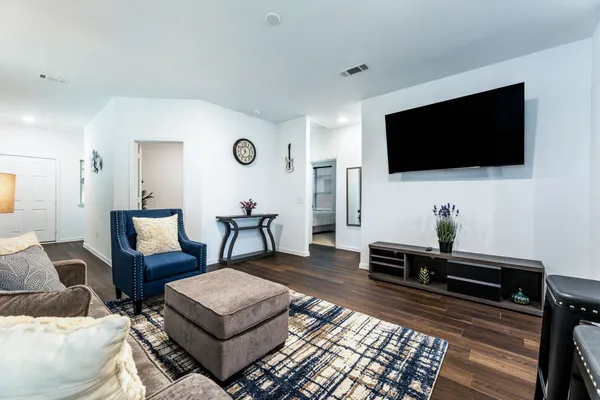 a living room with furniture and a flat screen tv