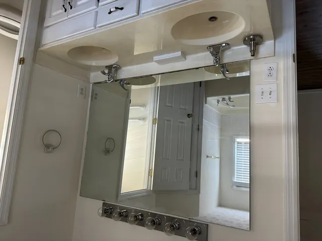 a bathroom with a shower and a mirror
