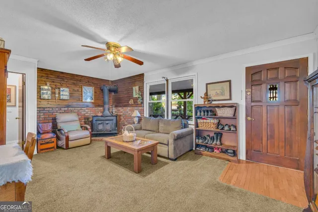 a kitchen with cabinets wooden floor and a window