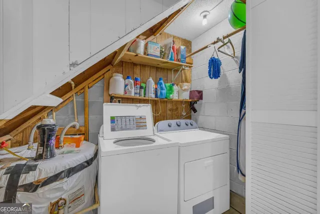 a view of swimming pool with seating area and trees in the background