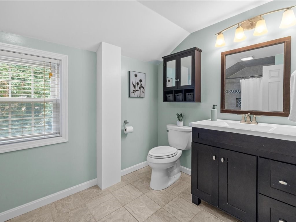 16 Lilly Lane Dedham, MA 02026 - Photo 15 of 27 a bathroom with a toilet sink a mirror and a window