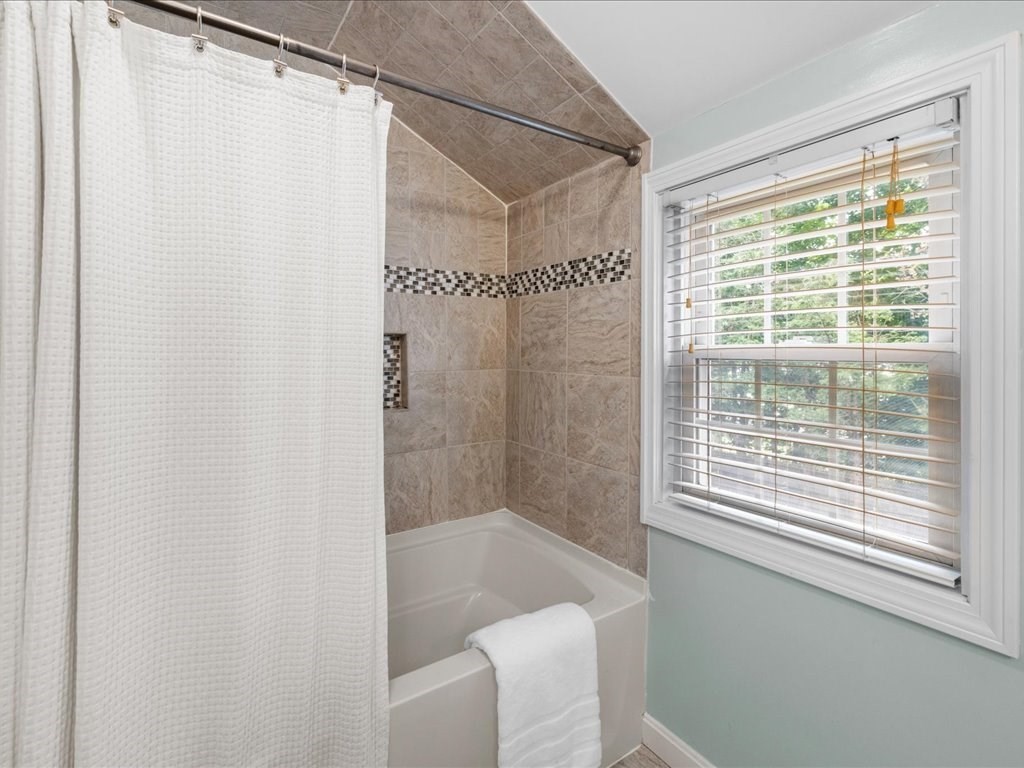 16 Lilly Lane Dedham, MA 02026 - Photo 16 of 27 a bathroom with a shower and a window