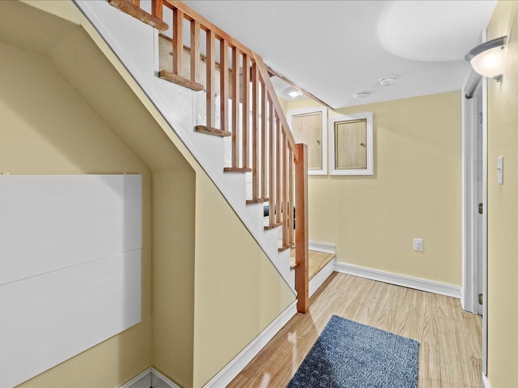 16 Lilly Lane Dedham, MA 02026 - Photo 20 of 27 a view of entryway with wooden floor and stairs