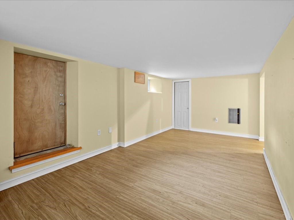 16 Lilly Lane Dedham, MA 02026 - Photo 21 of 27 a view of an empty room with wooden floor and a window