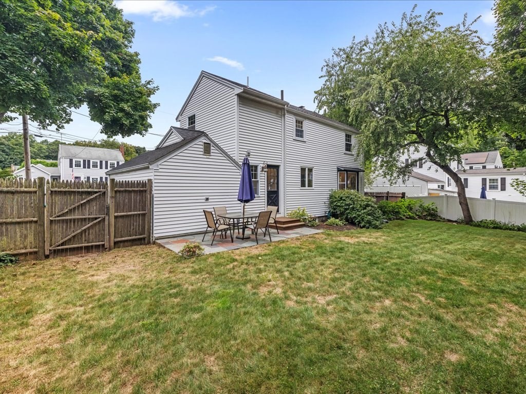 16 Lilly Lane Dedham, MA 02026 - Photo 24 of 27 a white house that has a tree in front of it