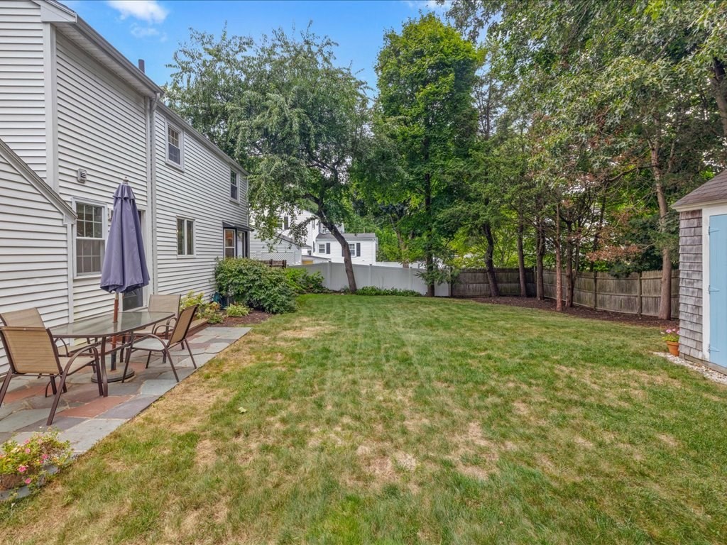 16 Lilly Lane Dedham, MA 02026 - Photo 25 of 27 a backyard of a house with table and chairs