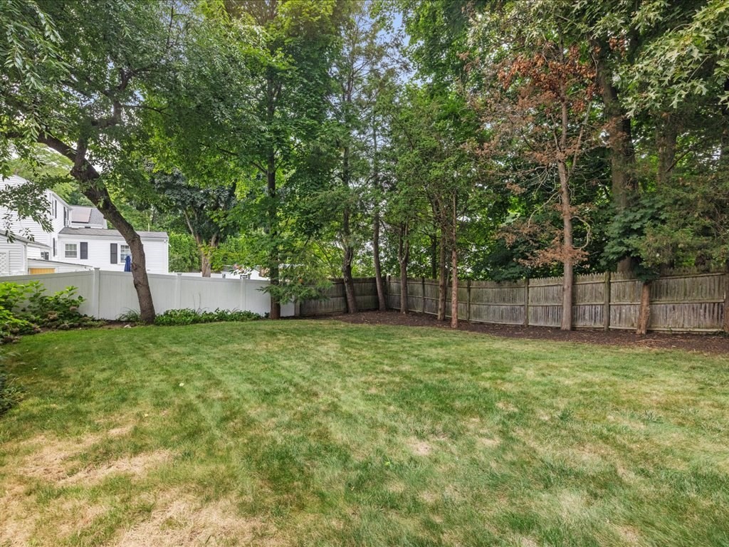 16 Lilly Lane Dedham, MA 02026 - Photo 26 of 27 a house is sitting in middle of the green field
