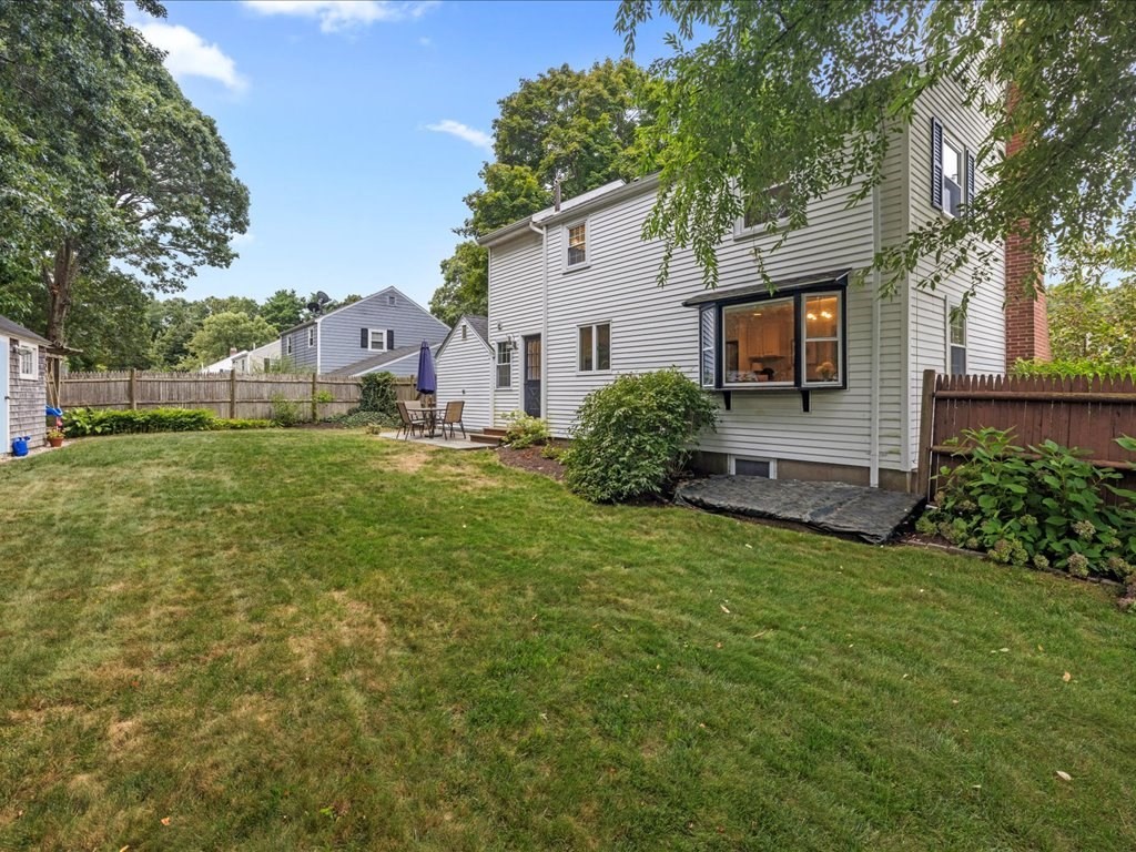 16 Lilly Lane Dedham, MA 02026 - Photo 27 of 27 a front view of a house with a yard and garage