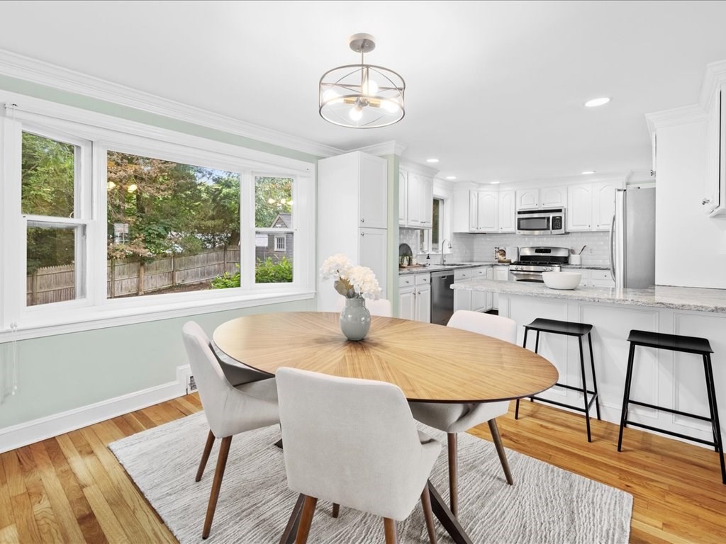 16 Lilly Lane Dedham, MA 02026 - Photo 7 of 27 a kitchen with dining table and chairs