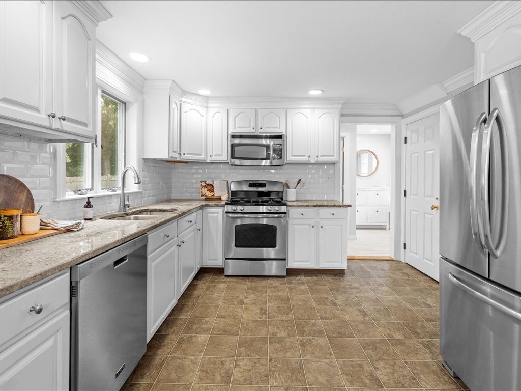 16 Lilly Lane Dedham, MA 02026 - Photo 10 of 27 a kitchen with stainless steel appliances a refrigerator sink and white cabinets