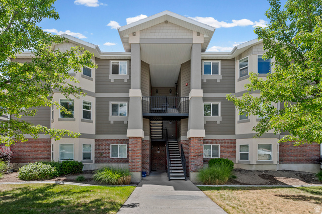 8248 South Resaca Drive, Unit J10 Sandy, UT 84070 - Photo 1 of 40 Multi-story building featuring a brick base with siding and shake accents