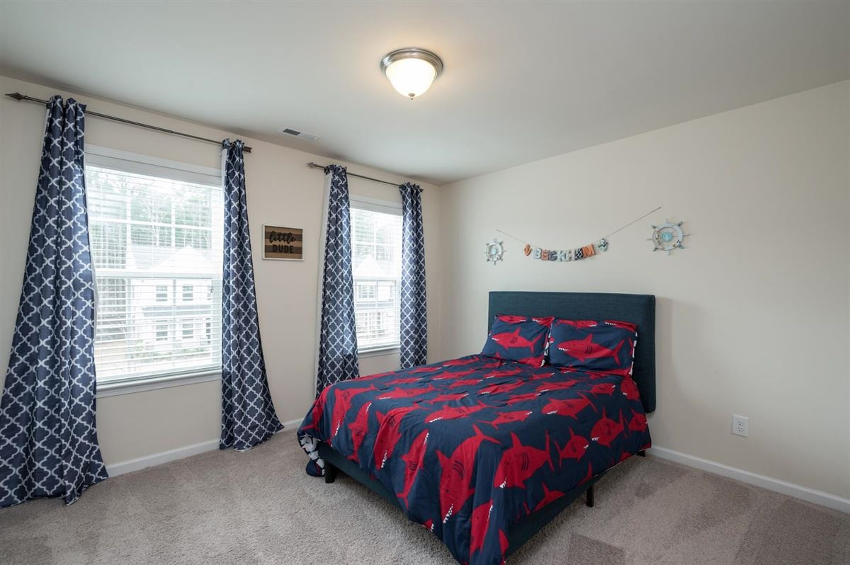 409 Morgan Ridge Road Holly Springs, NC 27540 - Photo 22 of 30 One of three secondary bedrooms upstairs, featuring a walk-in closet! Bedroom