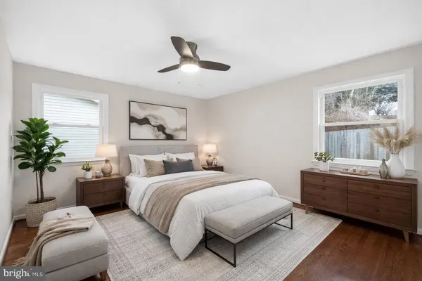 a bedroom with a bed and a potted plant